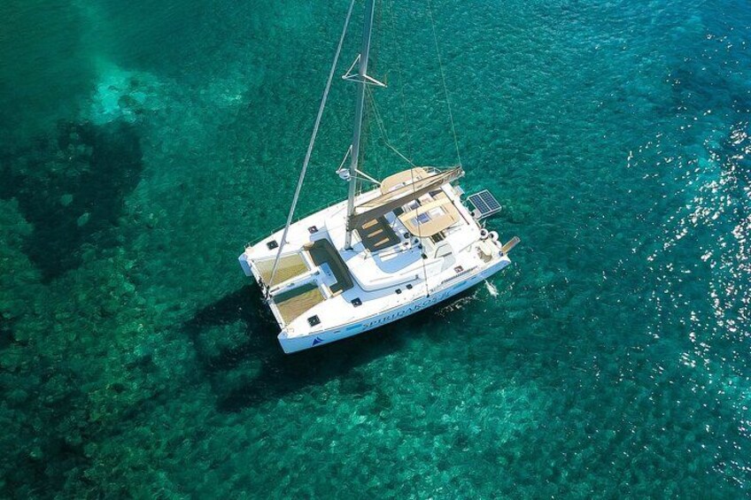 Green or Blue? It does not matter. Experience the ultimate in luxury and comfort! Relax and unwind on our Lagoon catamaran, designed for an unforgettable Santorini sailing experience. 2
