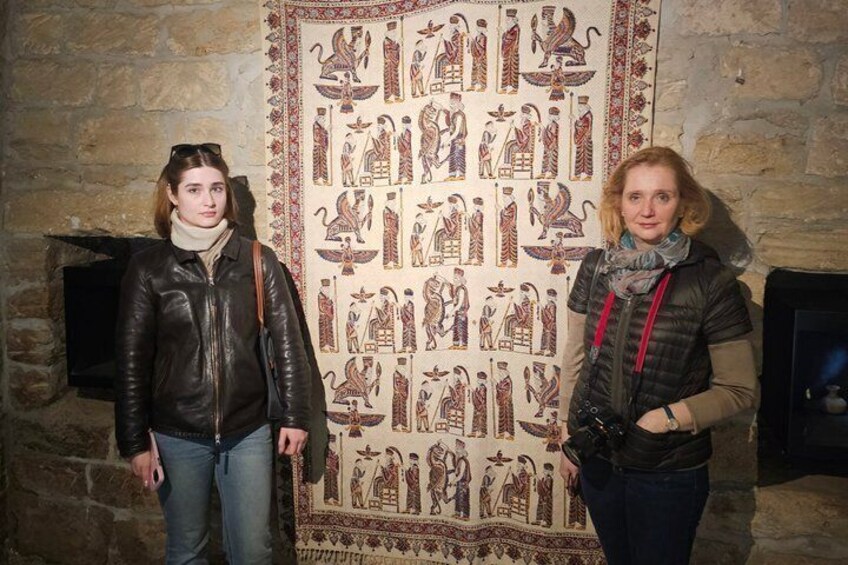 Two individuals standing in front of a wall with ancient Egyptian hieroglyphs. 4