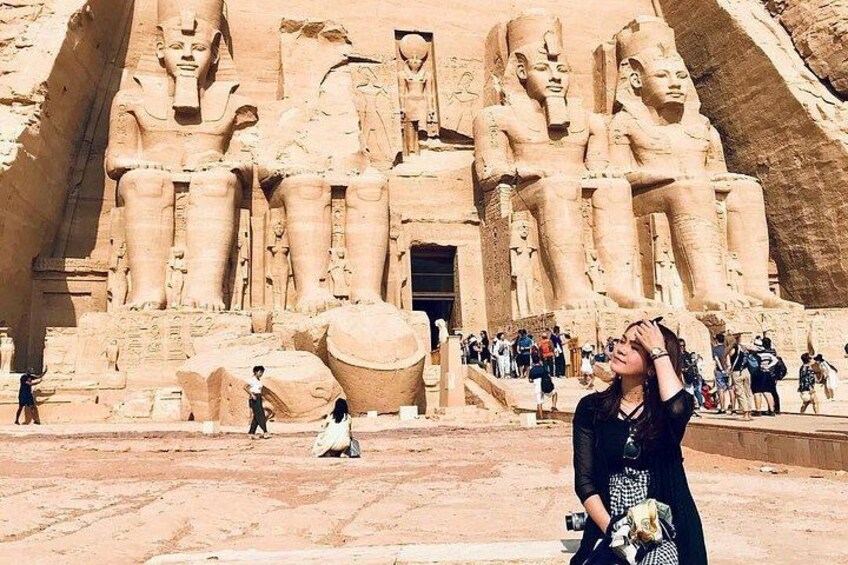 A large ancient Egyptian temple with colossal statues of pharaohs. 4