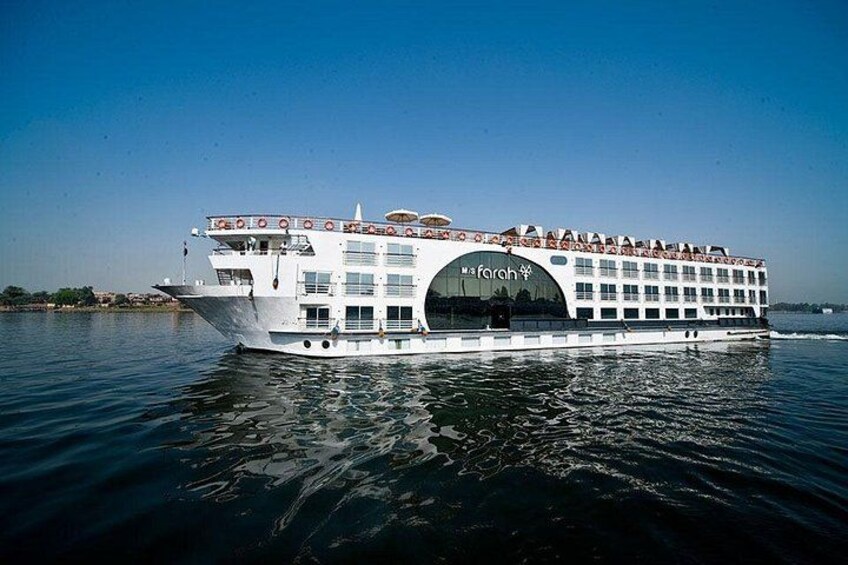 A large white river cruise ship with multiple decks and a prominent logo on the side. 3