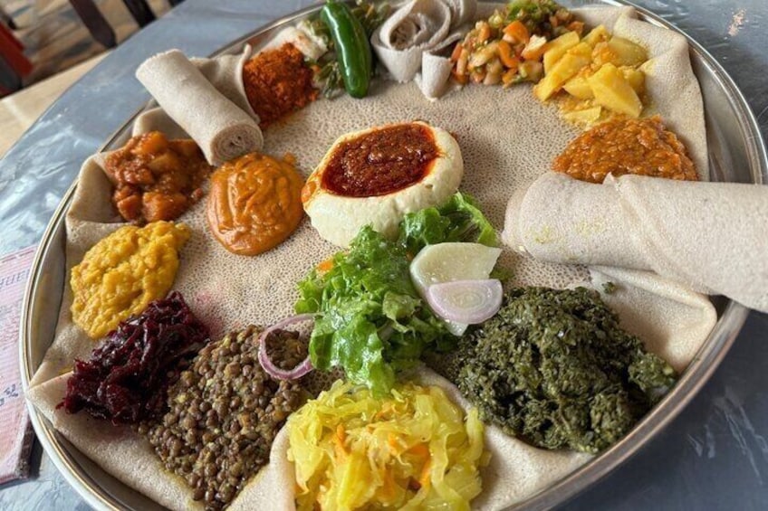 A traditional Ethiopian meal with injera, various stews, and salads. 4