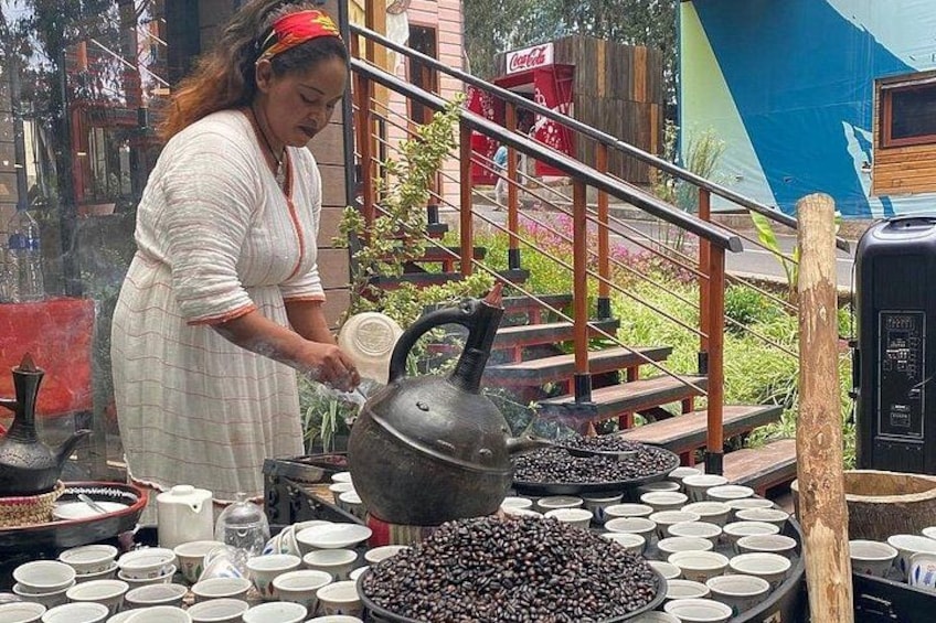 A person cooking with a kettle and various bowls of ingredients. 2