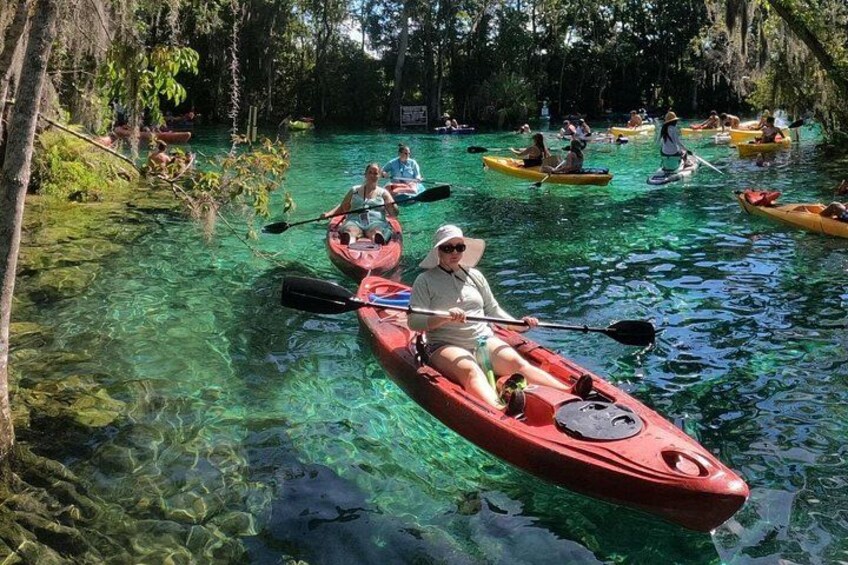 Personas haciendo kayak en un río claro rodeado de árboles. 2