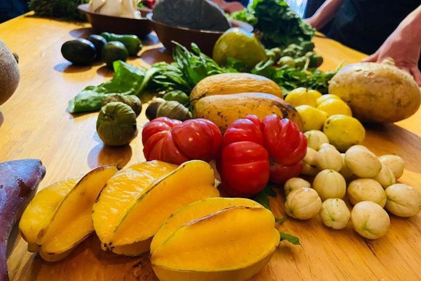 A variety of fresh vegetables and fruits on a wooden table. 2