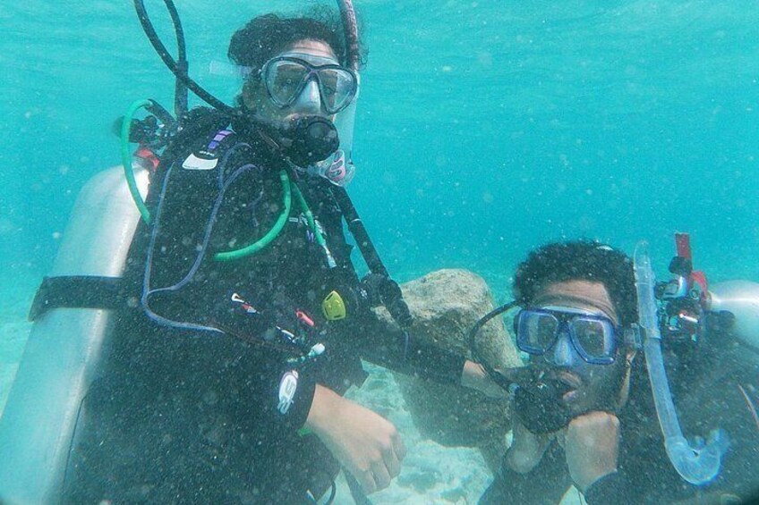 Two people scuba diving with equipment. 4