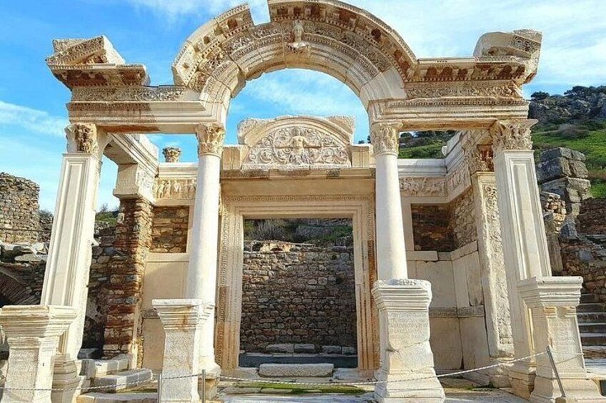 Ancient ruins with a large archway and columns. 1