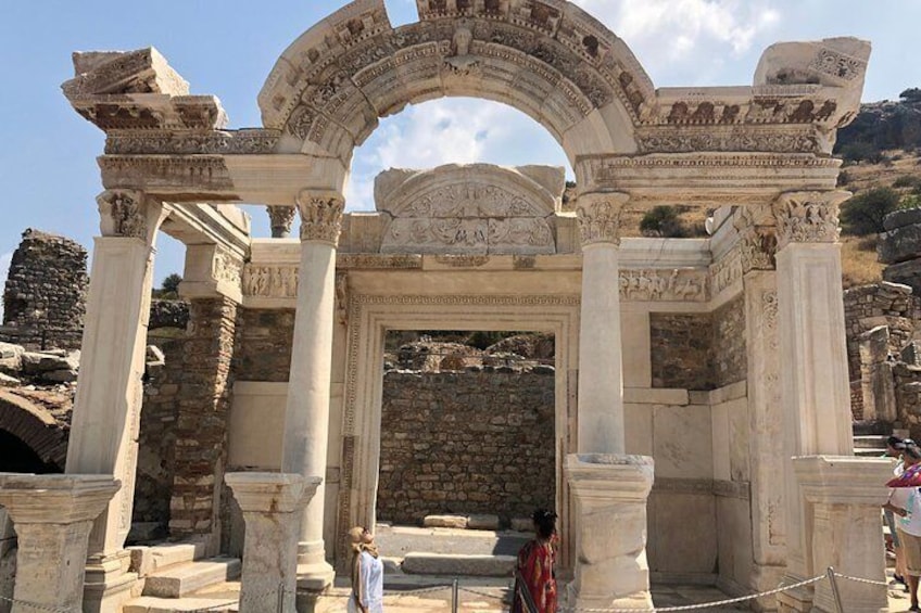 Ancient ruins with a large archway and columns. 5