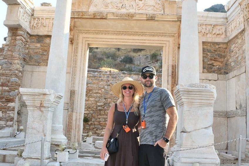 A historical site with ancient columns and a large archway. 5