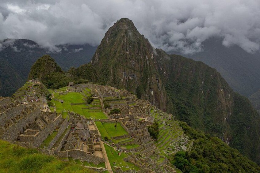 Machu Picchu, ancient Incan ruins, with terraced fields and steep mountain backdrop. 4