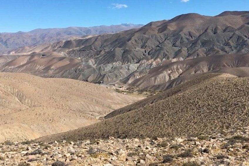 A desert landscape with rolling hills and a valley. 3
