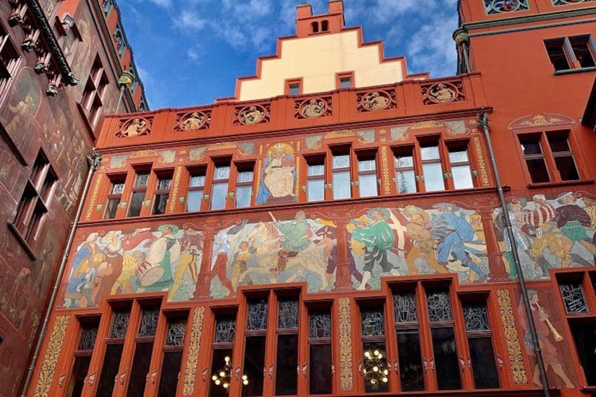 A building with ornate architectural details and colorful murals. 2