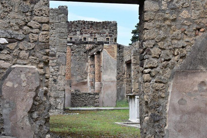 Ancient stone ruins with columns and a partially intact structure. 5