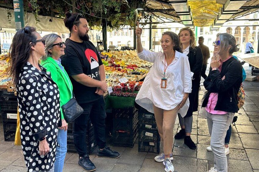 People at an outdoor market with fresh produce. 3