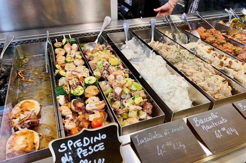 A buffet with various food options including shrimp, vegetables, and rice. 2