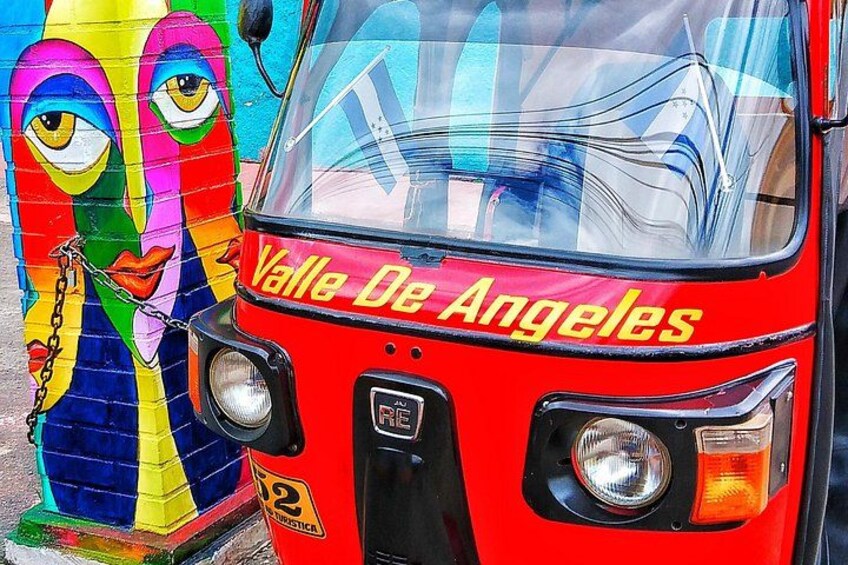 A red bus with 'Valle De Angeles' written on the front. 2