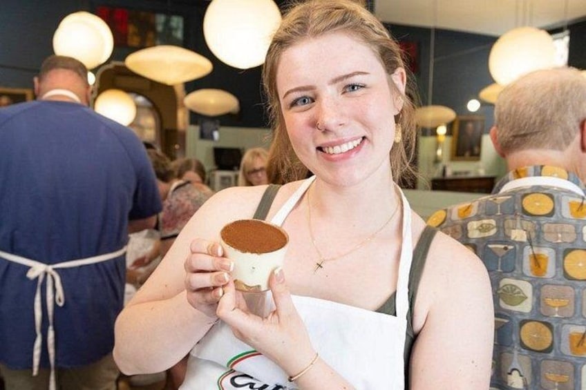 Showing off homemade Tiramisu always with a smile. 4