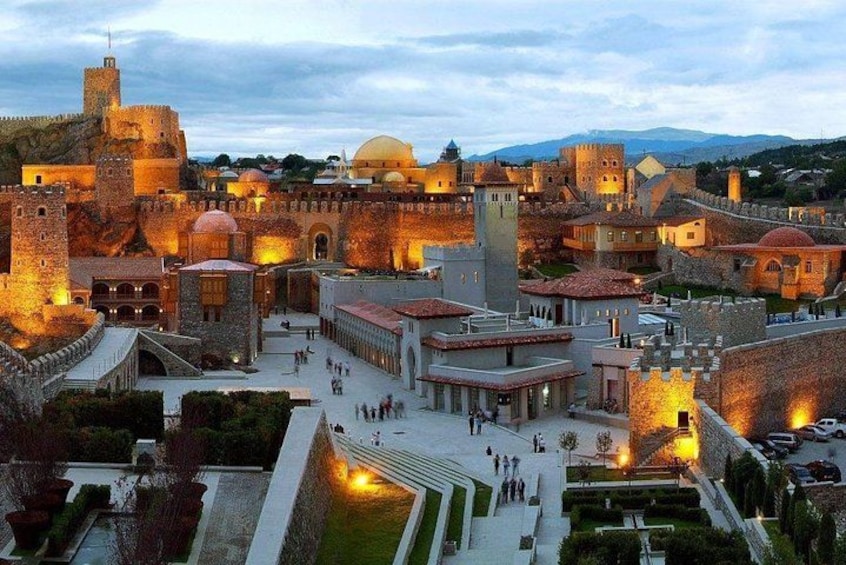 A historic walled city with ancient architecture, including domed buildings and towers. 5