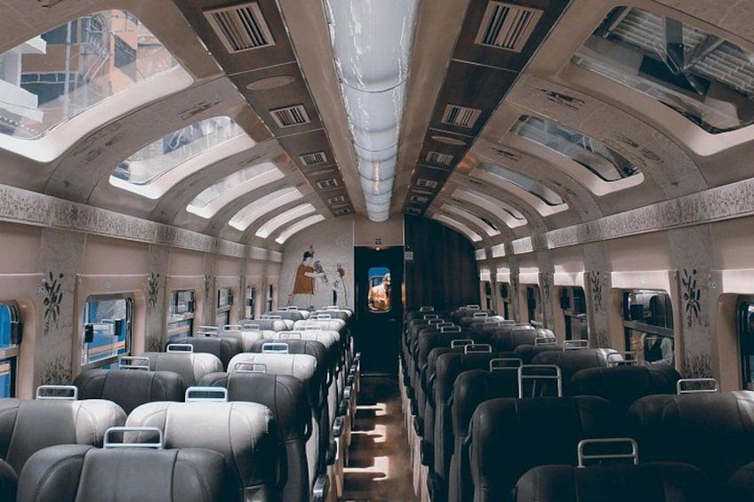 A spacious airplane interior with rows of seats and overhead compartments. 3
