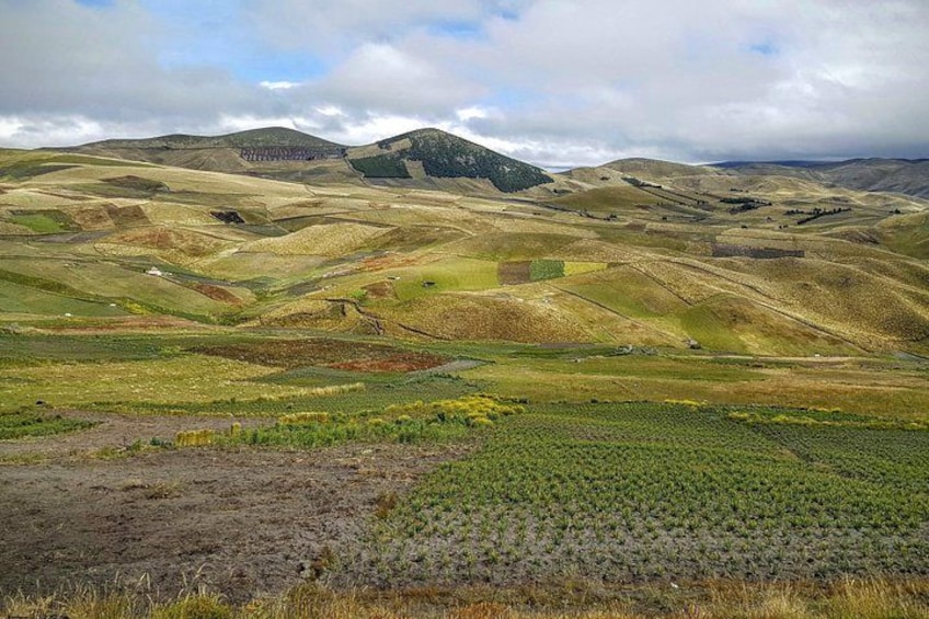 Rolling hills, a valley, and a distant mountain range. 4