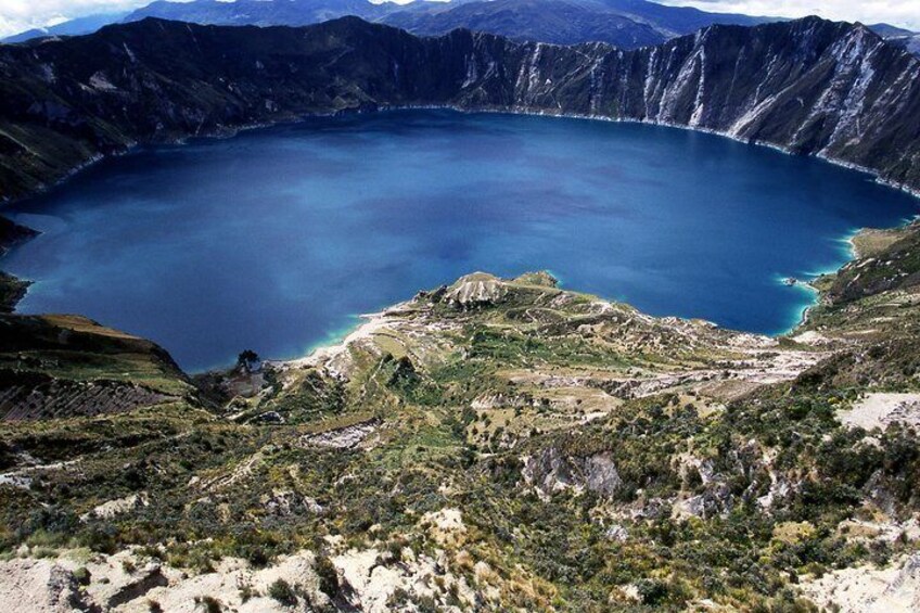 A large crater lake surrounded by rugged mountains. 3