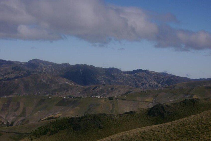 A mountainous landscape with rolling hills and sparse vegetation. 2