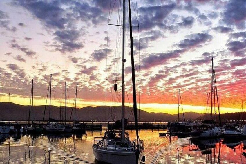A marina with sailboats at sunset. 4