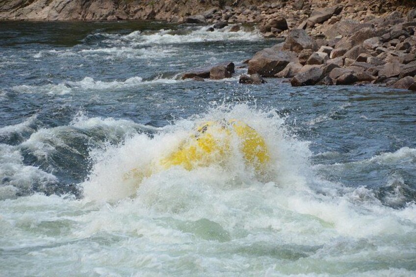 A yellow object being swept away by a fast-flowing river. 2