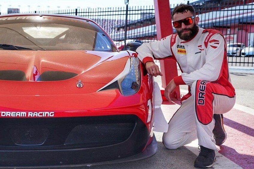 A red sports car with 'DREAM RACING' written on the front, a person in racing gear, and a racing track in the background. 3