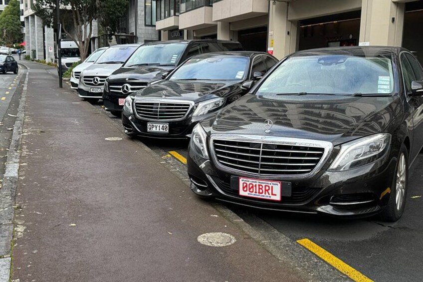 A row of parked cars on a city street. 4