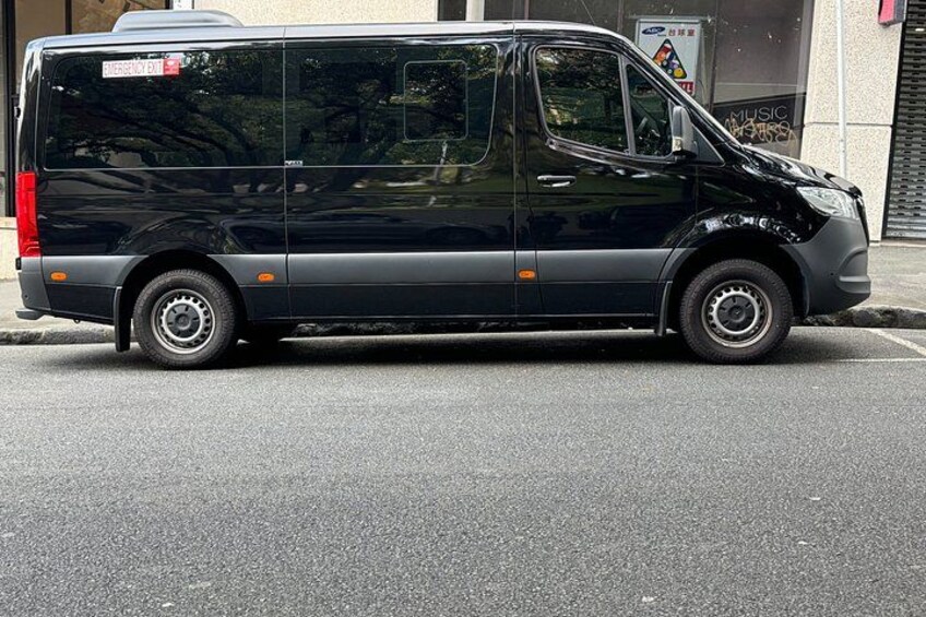 A black van parked on a street. 3
