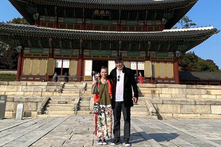 A traditional Korean building with a tiled roof and wooden structure. 4