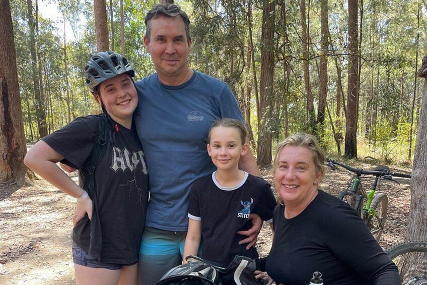 A family in a forest with a bicycle. 3
