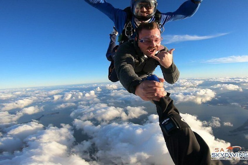 Une personne qui fait du parachutisme en tenant la main d’une autre personne. 2