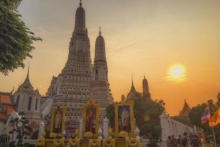 A temple complex with multiple spires and golden decorations during sunset. 3