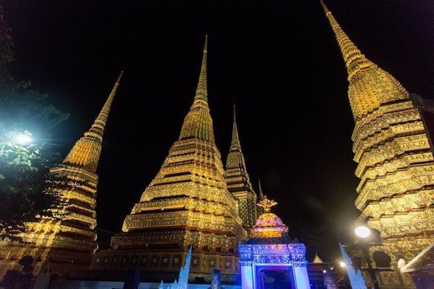 A night view of a temple complex with multiple tiered spires. 2