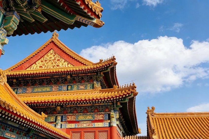 A traditional Chinese building with ornate golden roofs and detailed blue and red decorations. 3