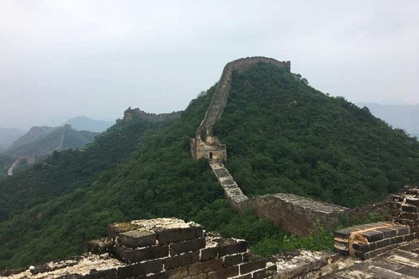 The Great Wall of China winding through a mountainous landscape. 4