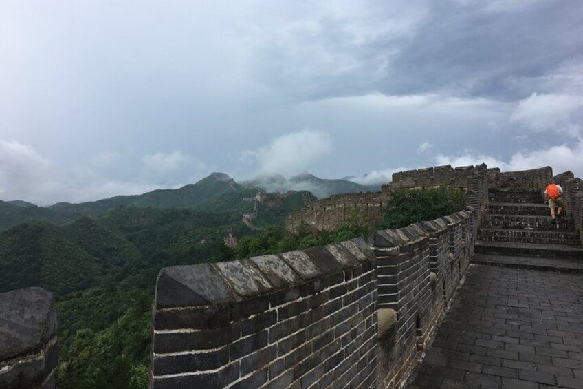 A section of the Great Wall of China with a person climbing the steps. 2