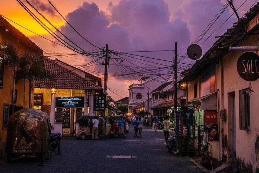 A street at dusk with buildings, a sign for 'Salt', and a 'Hutch' store. 5