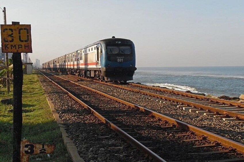 A train traveling on tracks near a body of water. 2