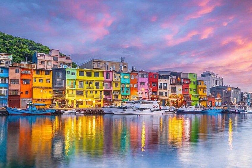 A waterfront with colorful buildings and boats. 2