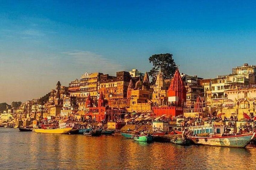 A riverside cityscape with colorful buildings and boats on the water. 4