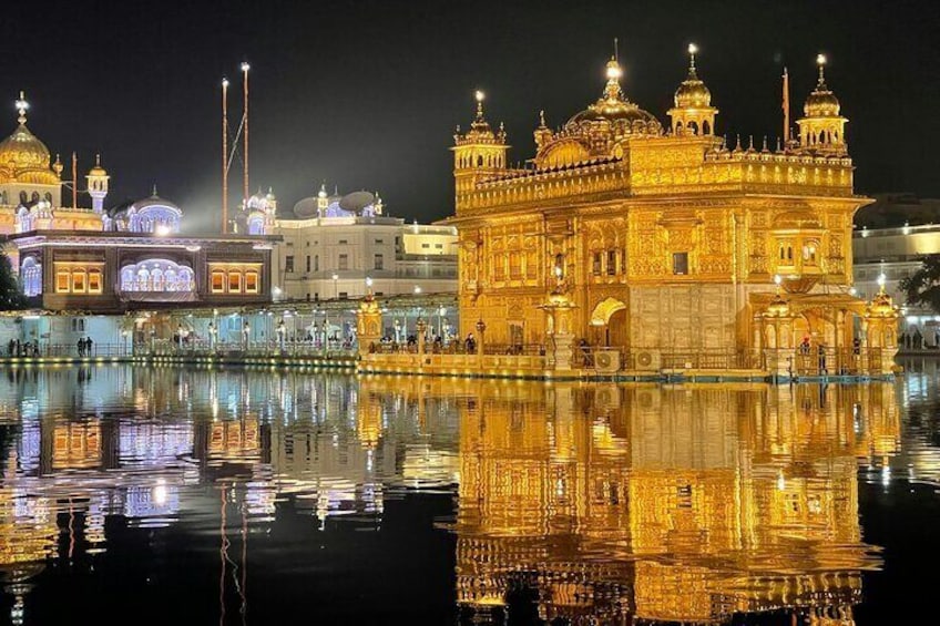 The Golden Temple at Amritsar, India, illuminated at night with its reflection in the water. 1