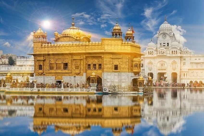 The Golden Temple with its reflection in the water, surrounded by a serene lake. 5