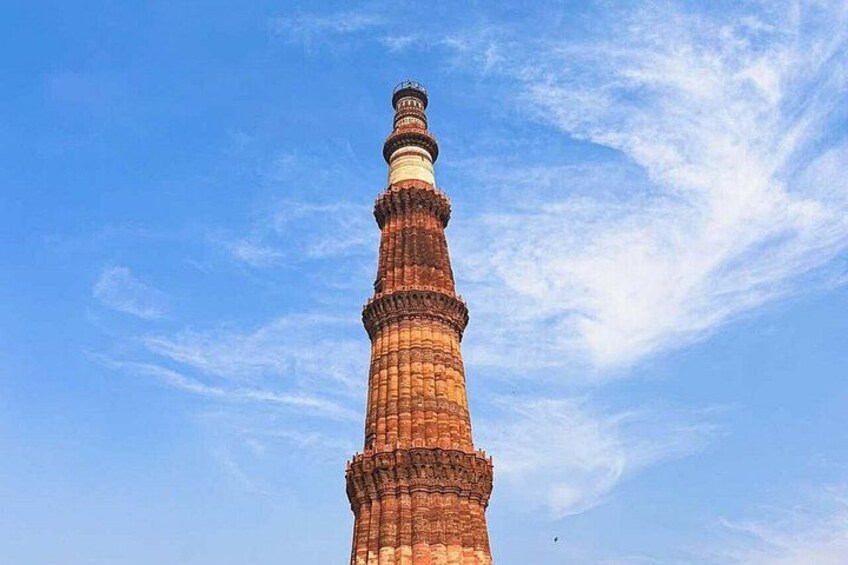 A tall, cylindrical tower with a spiral staircase, set against a clear blue sky. 5
