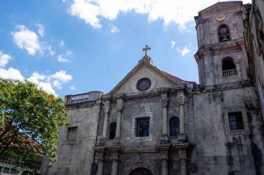 A historic church with a bell tower and a cross on top. 2