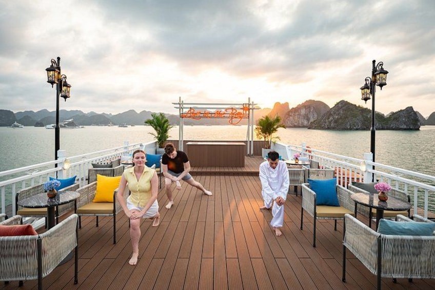A wooden deck with outdoor seating, a body of water, and distant mountains. 3