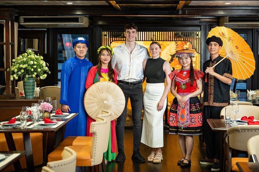 A group of people in traditional attire standing in a restaurant. 4