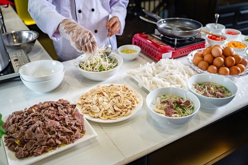 A chef preparing food with various ingredients on a kitchen counter. 2