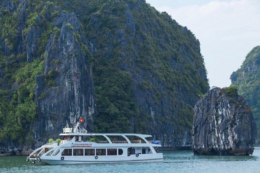 A boat on calm waters with a mountainous backdrop. 1